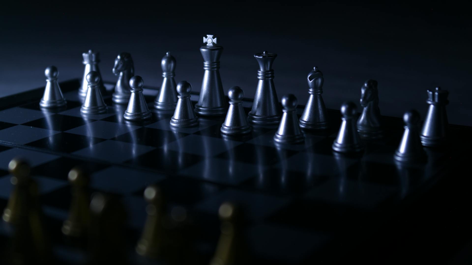 Moody chess set with dramatic lighting, highlighting strategic gameplay focus.